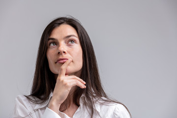 Thoughtful woman with her hand to her chin