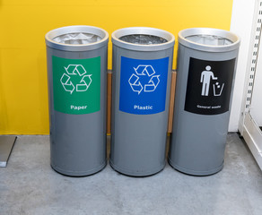 Different color trash cans in row for waste management. Perspective disposal view for saving environmental concept.