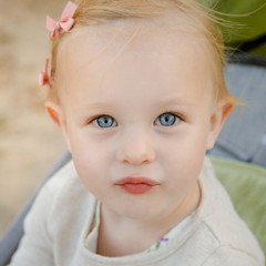 Close up portrait of little adorable girl with big blue eyes.