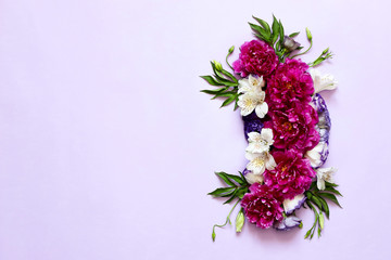 festive floral composition of peonies on pink and purple background .