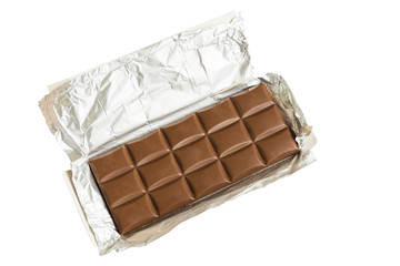 Tasty milk chocolate bar open in silver foil isolated on white background.
