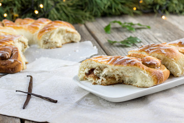 Pieces of a Christmas Cinnamon Wreath dessert with a vanilla pod