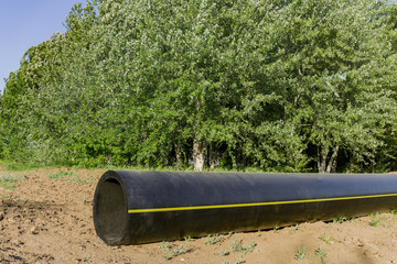 New pipeline of propylene DN 350 on a background of green forest