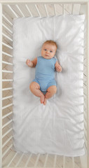 Baby in a cot - 205714941