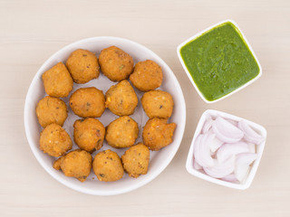 Indian Spicy Street Food Dal Vada Also Know as Moong Dal Vada, Pakoda, Pakode, Pakore, Moong Vada, Pakora or Bhajiya Served with Green Chutney or Onion