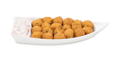 Indian Spicy Street Food Dal Vada Also Know as Moong Dal Vada, Pakoda, Pakode, Pakore, Moong Vada, Pakora or Bhajiya Served with Green Chutney or Onion isolated on White Background