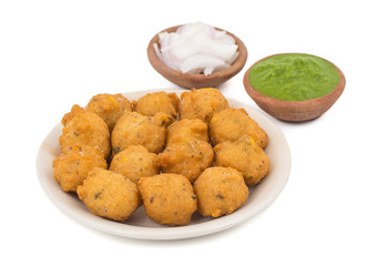 Indian Spicy Street Food Dal Vada Also Know as Moong Dal Vada, Pakoda, Pakode, Pakore, Moong Vada, Pakora or Bhajiya Served with Green Chutney or Onion isolated on White Background
