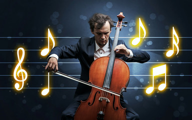 Young handsome cellist playing with music sheet background