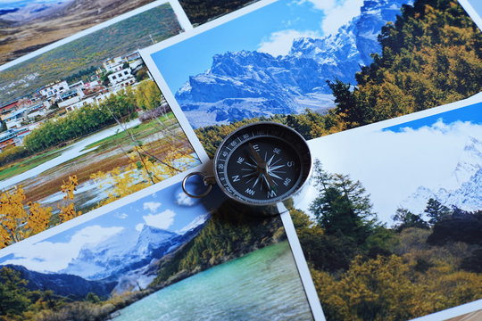 Compass on blur photograph of popular toustist destination background, China traveling concept