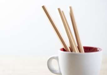 pencil on the white coffee cup on the white background