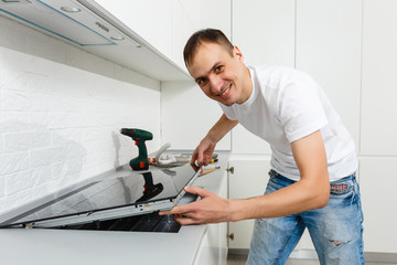 Installing new induction hob in modern kitchen