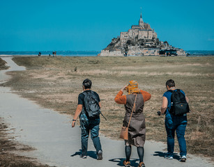 Three pilgrims walking to Mont St Michel