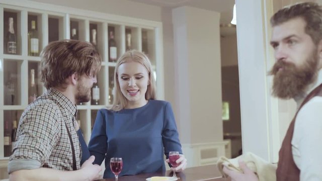 Attractive elegant young couple drinking a cocktail at the restaurant. Handsome loving couple flirting in a cafe. Love and romance. Lifestyle concept