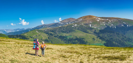 Fototapeta na wymiar Family of hikers on a trekking day
