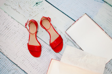 A pair of red sandals on the floor
