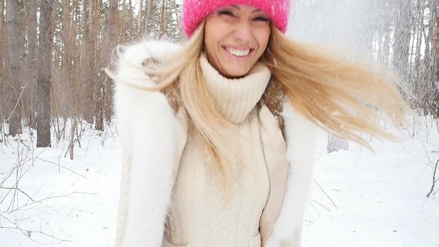 Young happy smile woman throws snow
