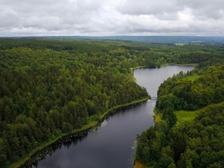 Obraz na płótnie Canvas Aerial lake view and bridge in the middle of a forest in Sweden during Summer