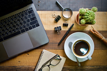Desk work coffee cup and laptop notebook pen on wooden table