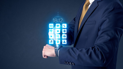 Businessman wearing smartwatch with application icons.
