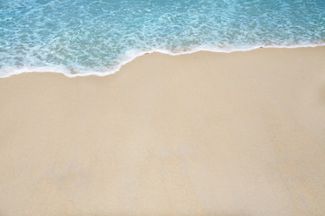 Fototapeta na wymiar Soft wave and sea bubble of blue sea on sandy beach
