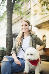 Happy girl sitting with her dog