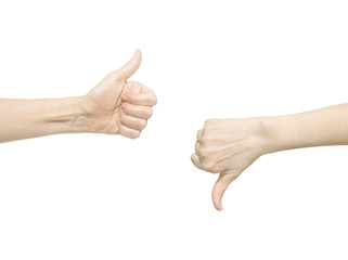 Closeup of two female hands showing thumb up and down signs against white background. Isolared...