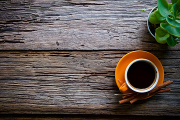 Coffee cup hot and notebook pen on wooden table desk 