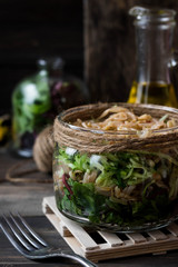 Salad from sprouts of sprouted soy and dandelion leaves in a jar