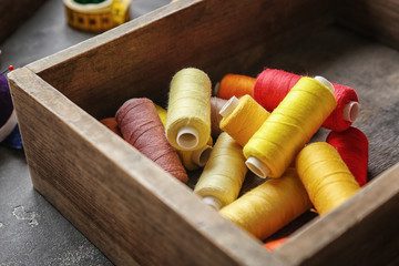 Fototapeta na wymiar Box with color sewing threads, closeup
