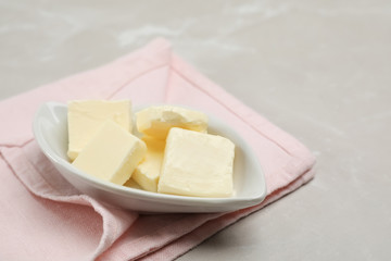 Plate with tasty fresh butter on table