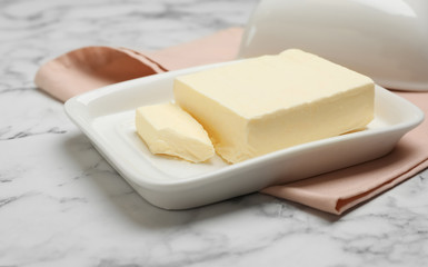 Plate with tasty fresh butter on table