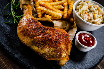 Roast chicken leg with chips and vegetables 
