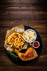 Roast chicken leg with chips and vegetables 