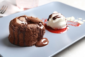 Delicious fresh fondant with hot chocolate and ice cream served on plate. Lava cake recipe