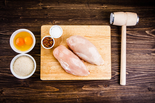 Raw chicken fillet on cutting board