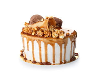 Delicious homemade cake with caramel sauce and popcorn on white background