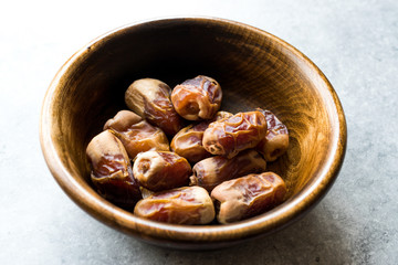 Dried date palm fruits or kurma, ramadan ( ramazan ) Medjool food in wooden bowl.