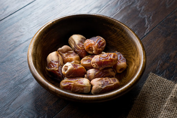 Dried date palm fruits or kurma, ramadan ( ramazan ) Medjool food in wooden bowl.