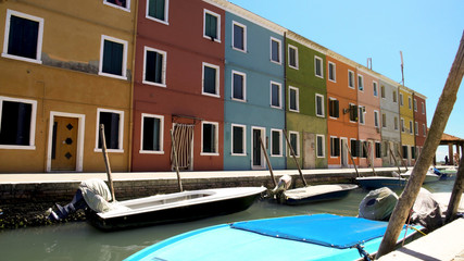 Fototapeta na wymiar Deserted street of Burano island, colorful houses with closed windows, Venice
