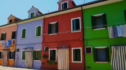 Fototapeta na wymiar Multicolored street on Burano, famous vivid architecture, tourist attraction