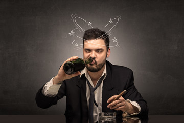 Young drunk man at his office with doodles around
