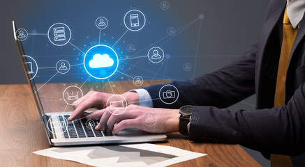 Businessman hand typing with cloud technology system and office symbol concept
