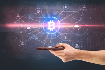Hand using phone with cryptocurrency bitcoin link network and online concept
