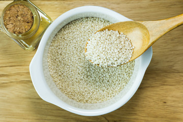  white Sesame seeds  on a old wooden table..