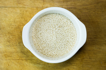  white Sesame seeds  on a old wooden table..