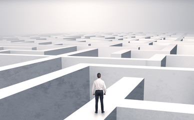 Small businessman in a middle of a huge maze
