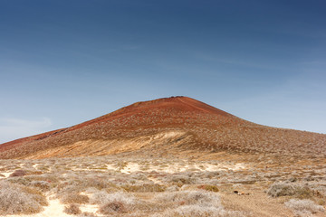 Fototapeta na wymiar Volcanic crater under a cloudless blue sky. La Graciosa, Lanzarote, Canary Islands, Spain.