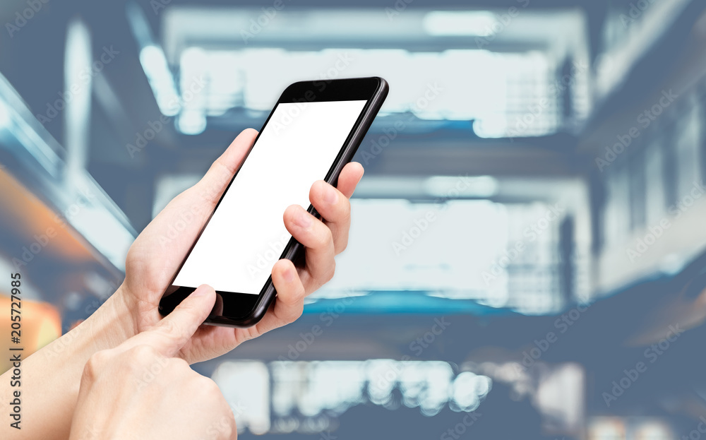 Aufkleber Hand click mobile phone with blur bank counter at corridor hall way background bokeh light,White screen mock up template for adding your design or your text