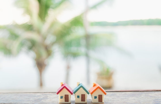 Miniature house on wooden background.Image for property real estate.