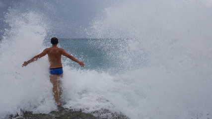 a man enters the raging sea